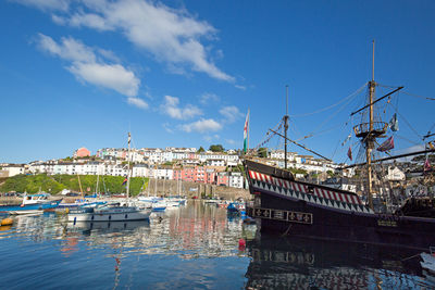 Boats in harbor with buildings in background