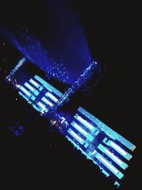 Low angle view of illuminated buildings against blue sky