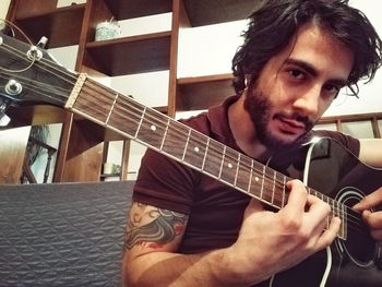 Portrait of man playing guitar