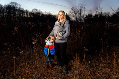 Full length of woman standing on field against sky