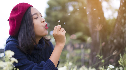 Portrait of young woman looking away outdoors