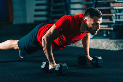 Male athlete doing push-ups in gym