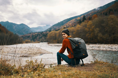 Full length of man standing on mountain against sky