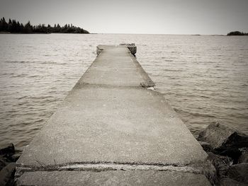 Pier over sea against clear sky