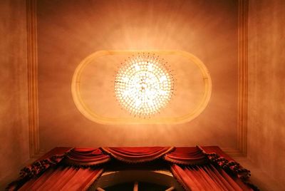 Low angle view of chandelier hanging from ceiling