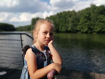 Portrait of girl standing at lake