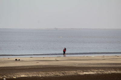 Couple on beach against sky