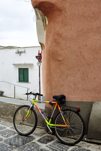 Bicycle parked on street against building