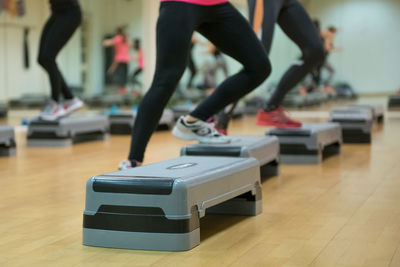 Low section of athletes exercising in health club