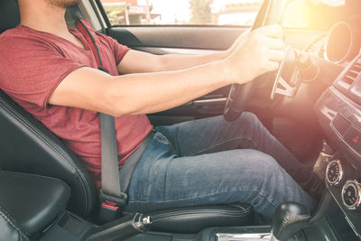 Midsection of man sitting in car
