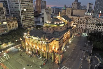 High angle view of city street and buildings at night