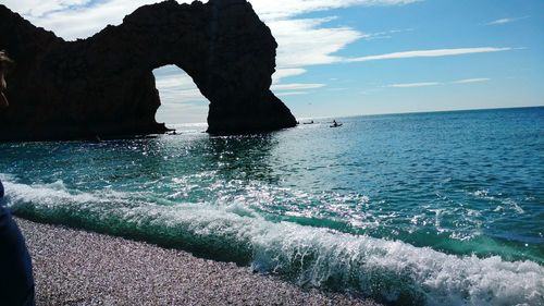 Rock formation in sea against sky