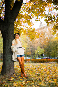 Side view of woman sitting on field