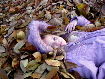 High angle portrait of woman lying down on bed