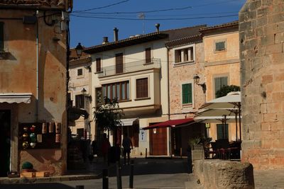 Residential buildings in city against sky