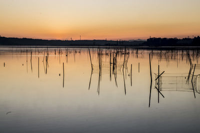 Scenic view of lake at sunset