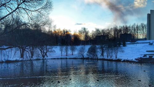 Scenic view of lake against sky during winter