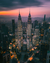 Illuminated cityscape against sky at night