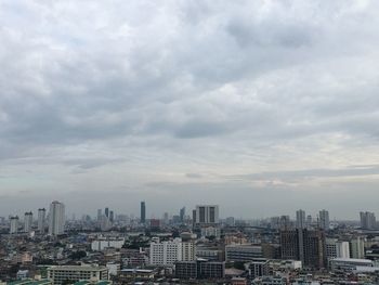 Aerial view of buildings in city against sky