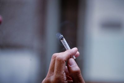 Cropped image of person smoking