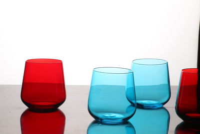 Close-up of glasses on table against white background