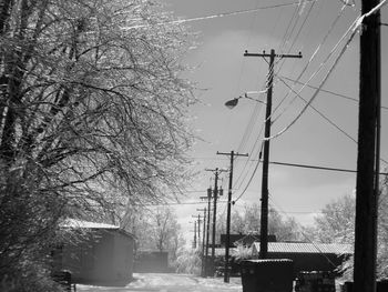 Low angle view of telephone pole against sky