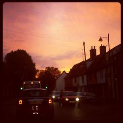 Cars on road at sunset