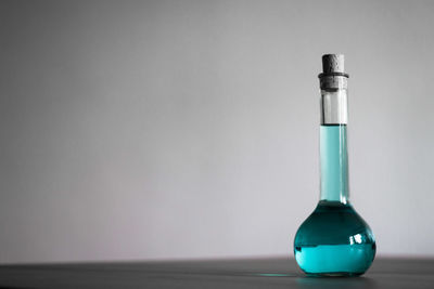 Blue liquid in glassware against gray background