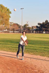 Full length of woman playing on field