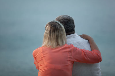 Rear view of couple looking at sea