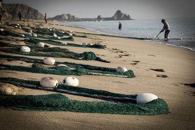 People playing with ball on beach