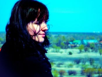 Close-up of young woman against sky