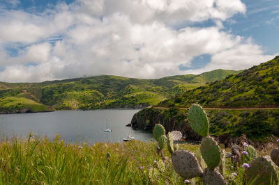 Scenic view of land and mountains against sky