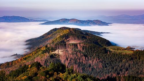 Scenic view of mountain against cloudy sky