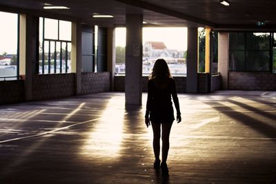 Rear view of woman in parking lot