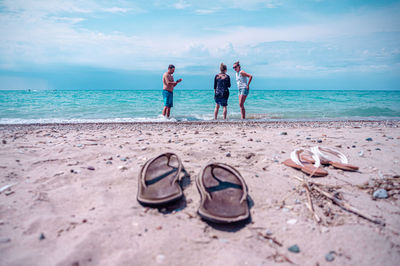 People on beach against sky