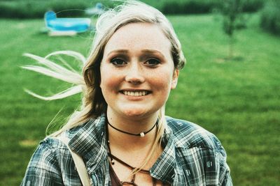 Portrait of smiling young woman standing outdoors