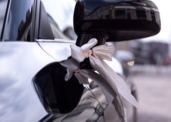 Close-up of white car on street