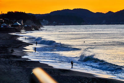 Scenic view of beach against sky during sunset