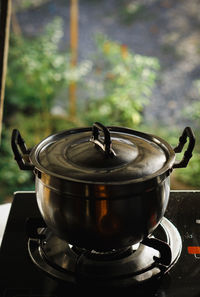 Close-up of tea cup on barbecue grill