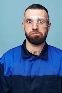 Portrait of senior man against blue background