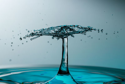 Close-up of water splashing against blue background