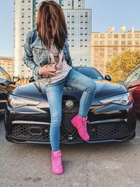 Full length of woman sitting in car