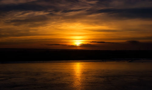 Scenic view of sea against romantic sky at sunset