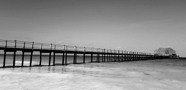 Bridge over sea against sky