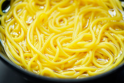 Close-up of yellow noodles in bowl