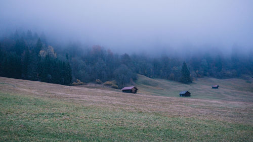 Scenic view of landscape against sky during foggy weather