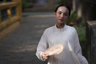 Portrait of a smiling woman standing outdoors