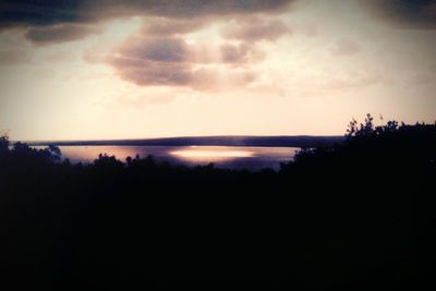 Scenic view of calm lake at sunset