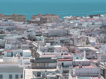 High angle view of cityscape by sea against sky